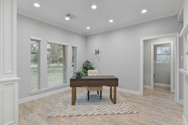 home office with ornamental molding and light hardwood / wood-style floors