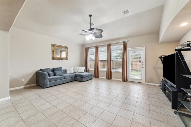 living room with vaulted ceiling, ceiling fan, and light tile patterned floors