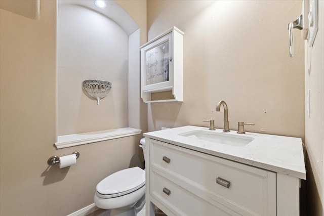 bathroom featuring toilet and vanity