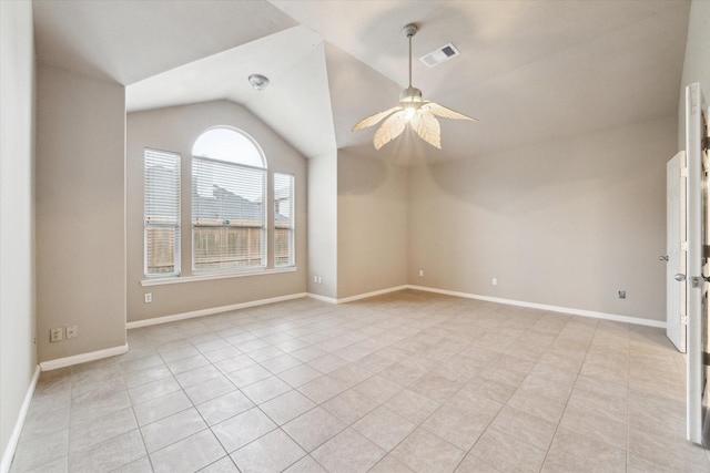 tiled empty room featuring lofted ceiling and ceiling fan