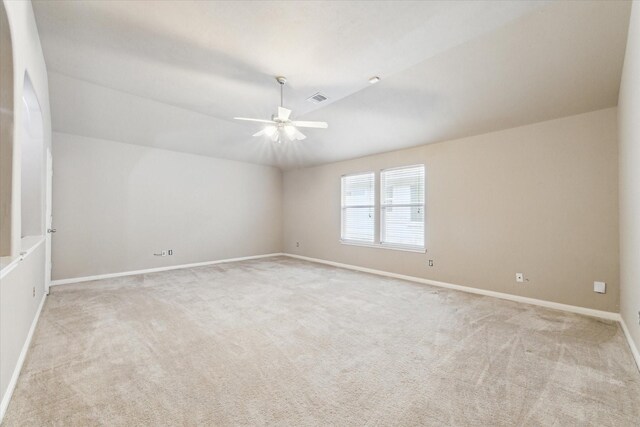 carpeted empty room with ceiling fan and vaulted ceiling