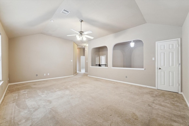 interior space featuring light colored carpet, ceiling fan, and vaulted ceiling