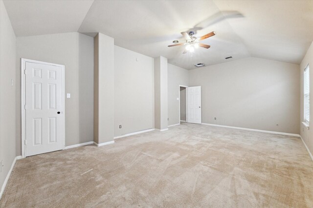 unfurnished room featuring ceiling fan, vaulted ceiling, and light carpet