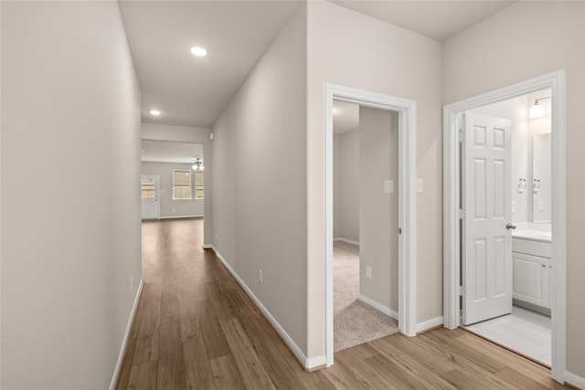 corridor with light wood-type flooring