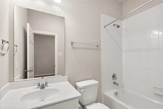 full bathroom featuring toilet, tiled shower / bath combo, and vanity