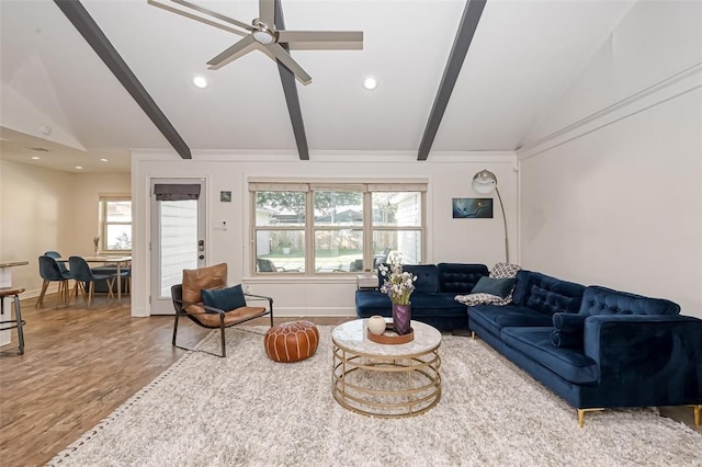 living room featuring ceiling fan, hardwood / wood-style floors, and vaulted ceiling with beams