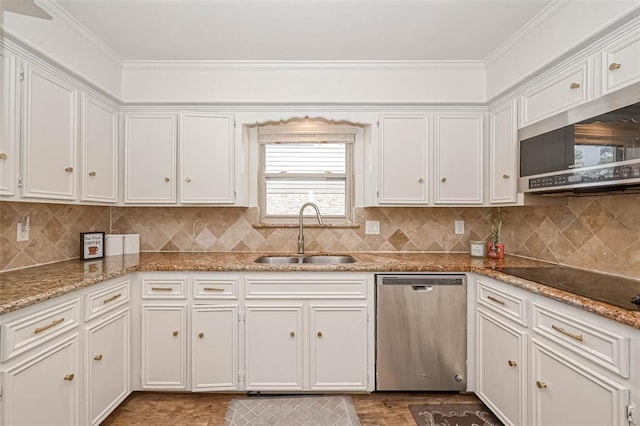 kitchen with appliances with stainless steel finishes, white cabinetry, and sink