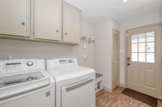 laundry room with cabinets and washer and clothes dryer