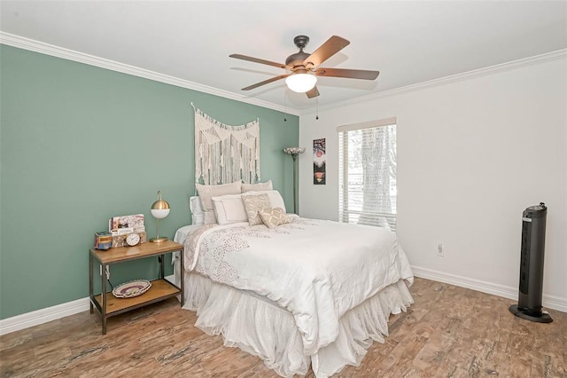 bedroom with ceiling fan, ornamental molding, and wood-type flooring