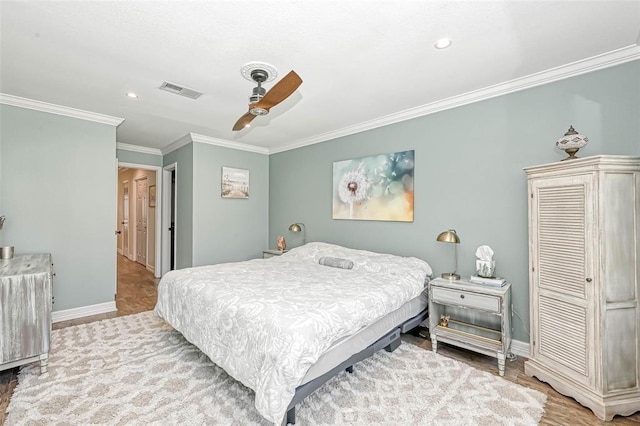 bedroom featuring wood-type flooring, ceiling fan, and crown molding