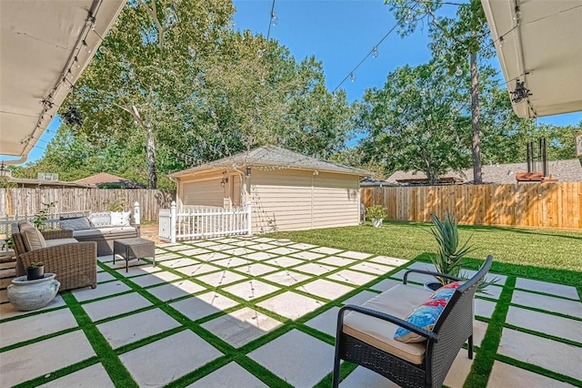 view of yard featuring a garage, an outbuilding, a patio, and an outdoor living space