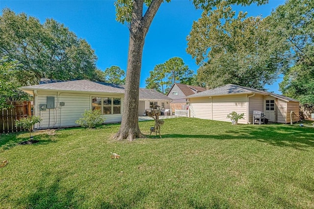 rear view of house with a lawn