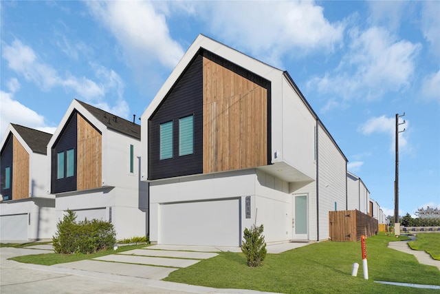 contemporary home with a front yard and a garage