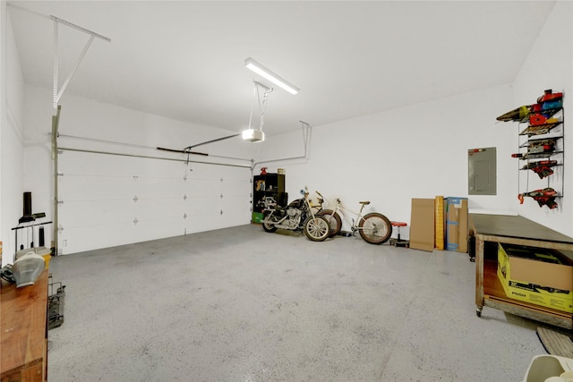 garage featuring electric panel and a garage door opener