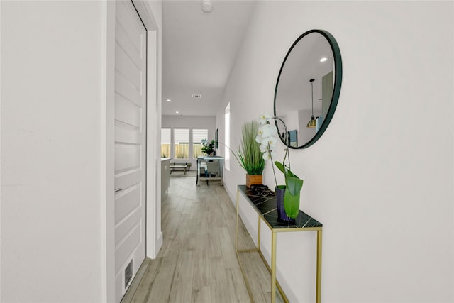 corridor with light hardwood / wood-style floors