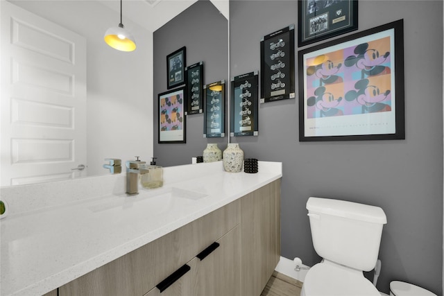 bathroom with vanity and toilet