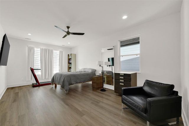 bedroom with ceiling fan and light wood-type flooring