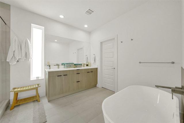 bathroom with vanity and a bath