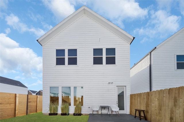 rear view of property with a yard