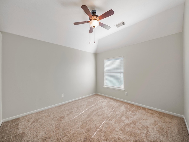 carpeted empty room featuring lofted ceiling and ceiling fan