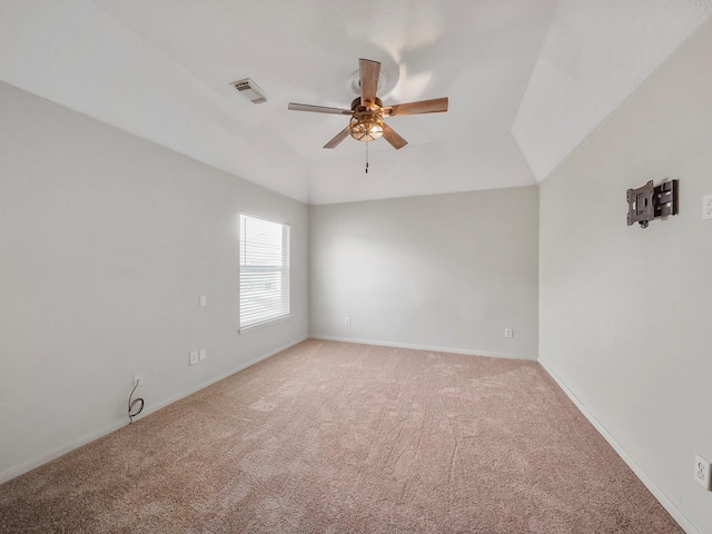 carpeted empty room featuring ceiling fan and vaulted ceiling