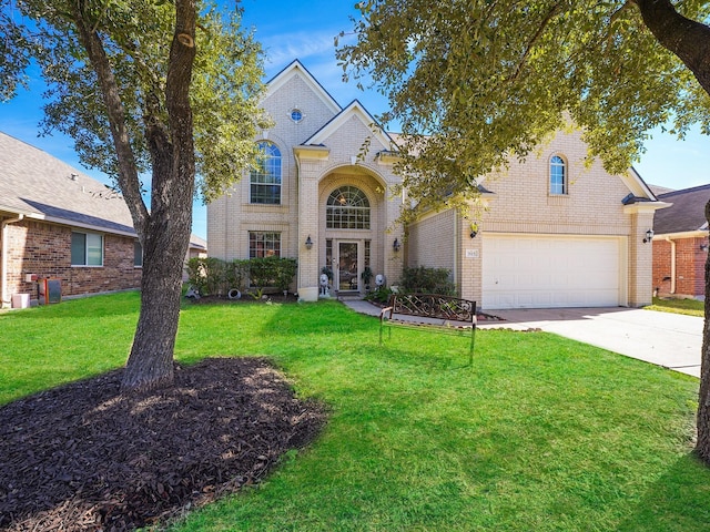 view of front facade with a front yard and a garage