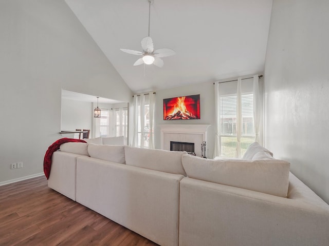 living room featuring high vaulted ceiling, a fireplace, hardwood / wood-style floors, and ceiling fan