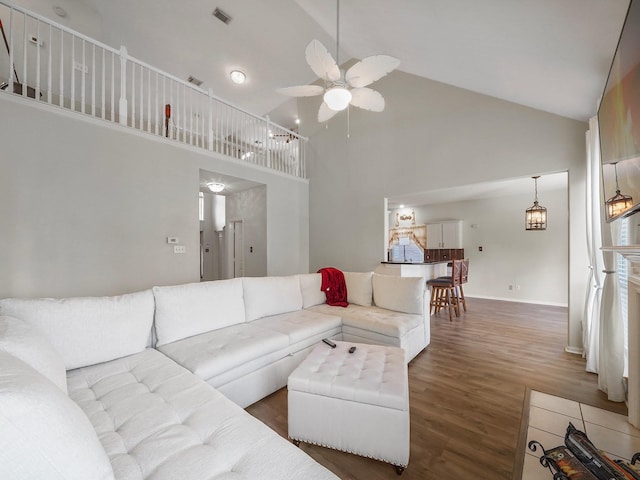 living room featuring high vaulted ceiling, dark hardwood / wood-style flooring, and ceiling fan