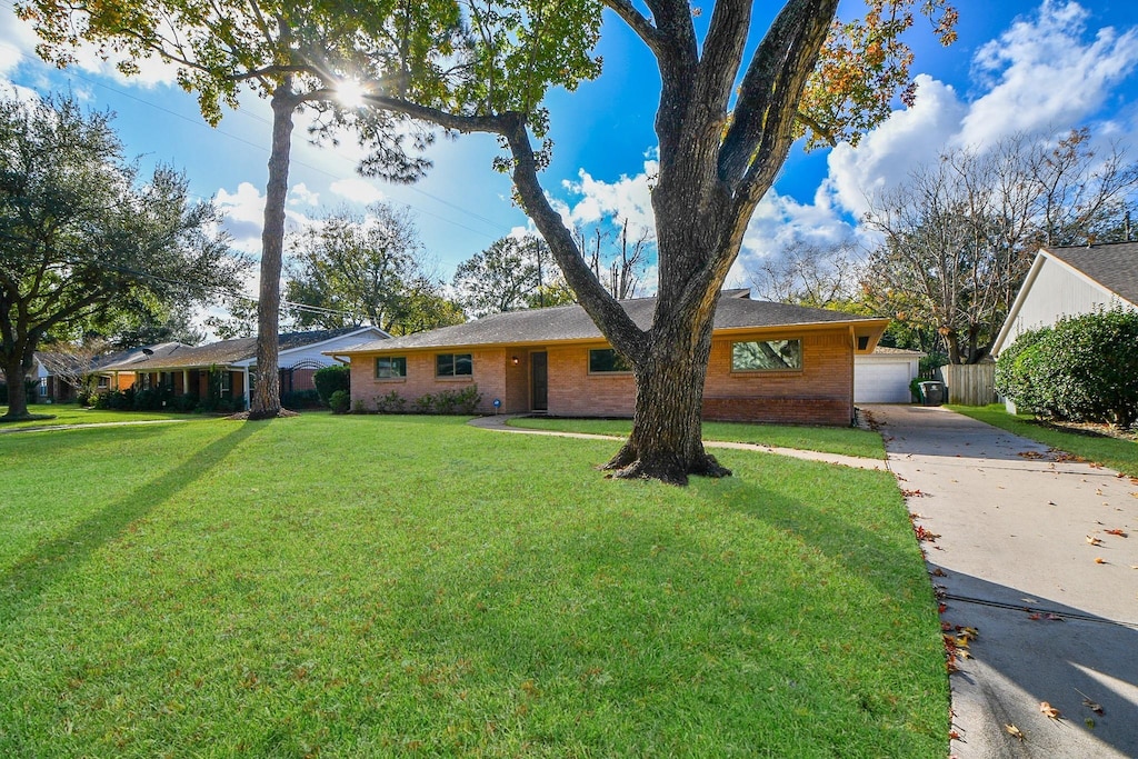 single story home with a front lawn and a garage