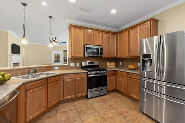 kitchen featuring tasteful backsplash, sink, hanging light fixtures, stainless steel appliances, and ornamental molding