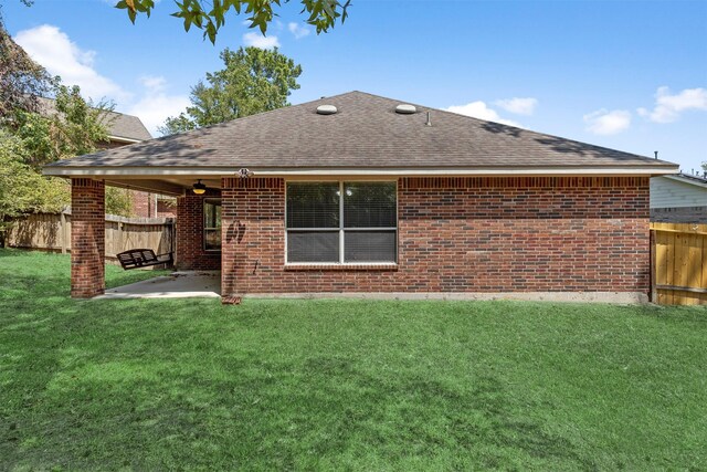 back of house featuring a yard and a patio