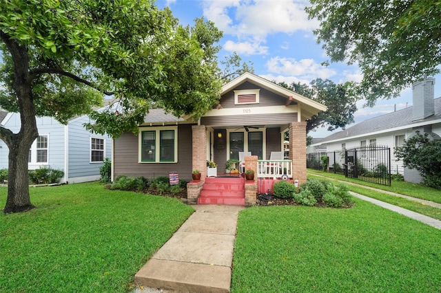 view of front of property with a front yard and covered porch