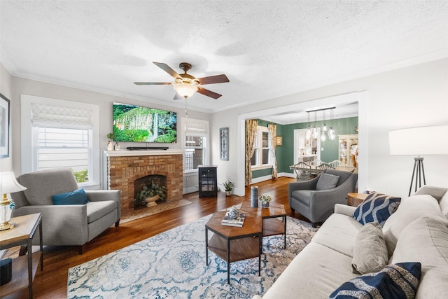 living room with a textured ceiling, ornamental molding, and dark hardwood / wood-style flooring