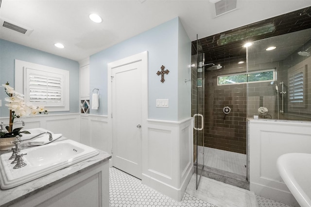 bathroom featuring tile patterned floors, an enclosed shower, and vanity