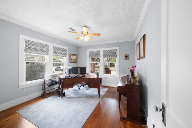 home office with a textured ceiling, dark hardwood / wood-style flooring, and a healthy amount of sunlight