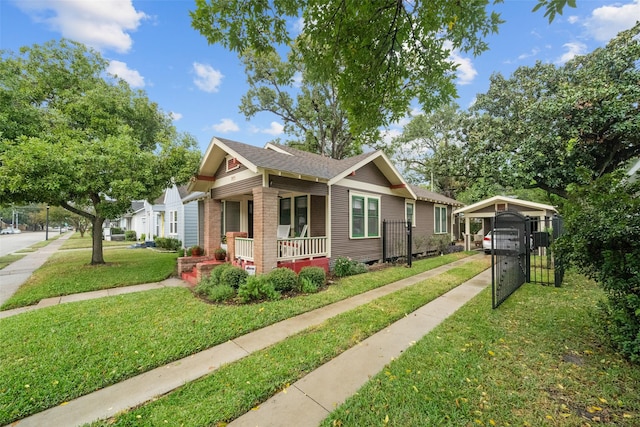 view of front of home featuring a front lawn, a carport, and a porch