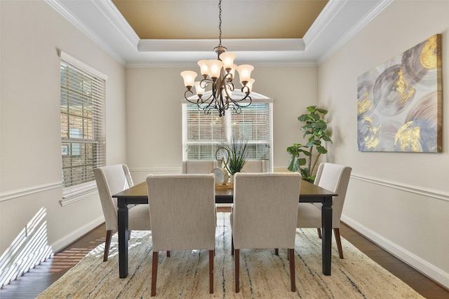 dining room featuring an inviting chandelier, a tray ceiling, and plenty of natural light