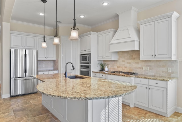 kitchen featuring appliances with stainless steel finishes, pendant lighting, white cabinetry, and premium range hood