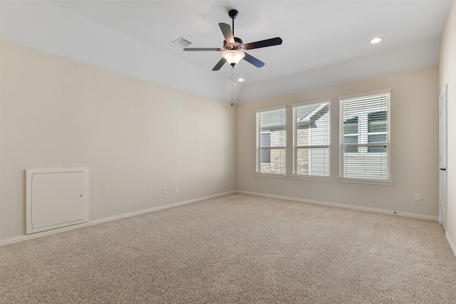 carpeted spare room with ceiling fan and vaulted ceiling