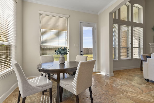 dining area featuring crown molding and plenty of natural light