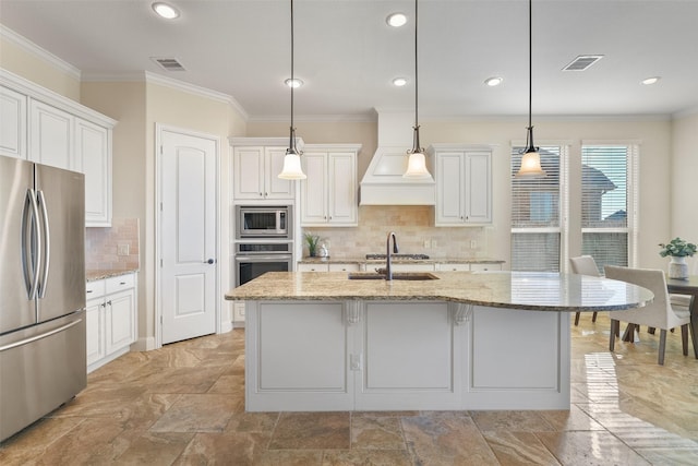 kitchen with white cabinets, stainless steel appliances, decorative light fixtures, and light stone countertops