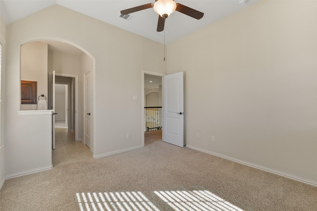 unfurnished bedroom with lofted ceiling, ceiling fan, and light colored carpet