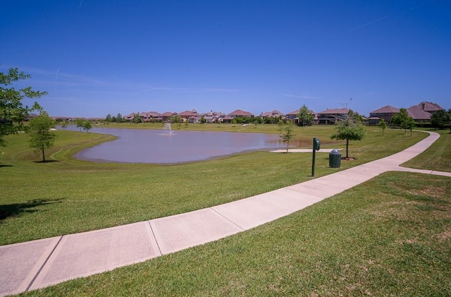 view of property's community featuring a yard and a water view