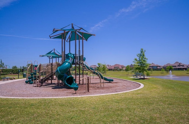 view of playground featuring a lawn and a water view