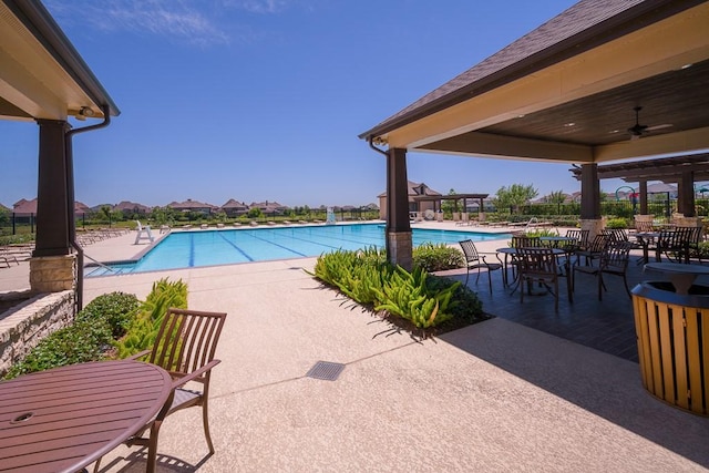 view of pool with ceiling fan and a patio