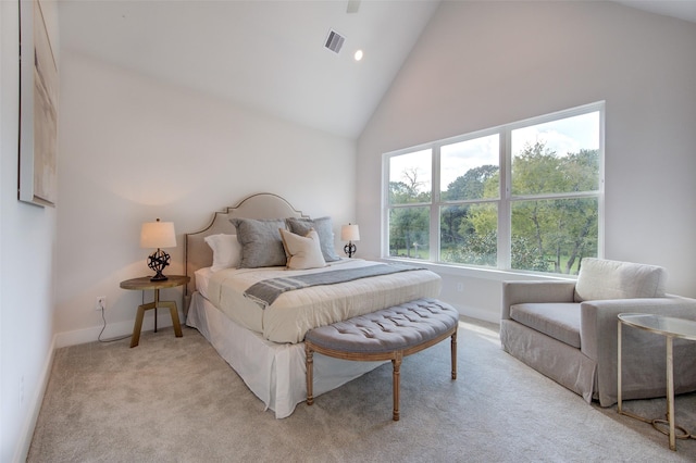 carpeted bedroom featuring high vaulted ceiling