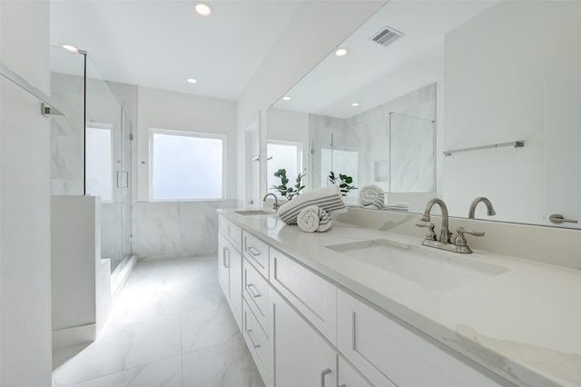 bathroom with tile walls, a shower with shower door, and vanity