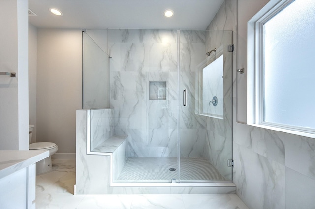 bathroom with toilet, an enclosed shower, vanity, and a wealth of natural light