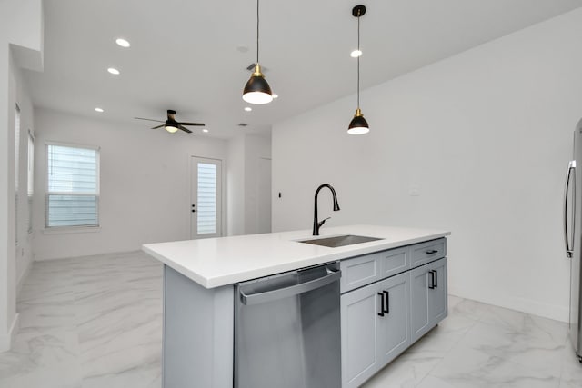 kitchen featuring sink, decorative light fixtures, ceiling fan, a kitchen island with sink, and appliances with stainless steel finishes