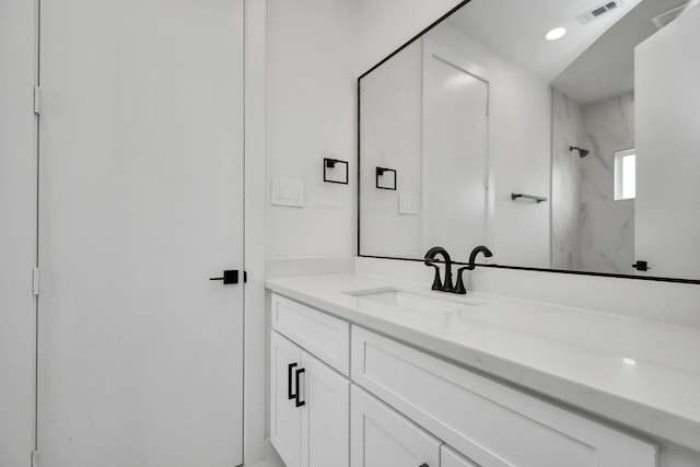 bathroom featuring vanity and a shower